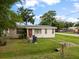 A charming home featuring a cozy front yard, classic architecture, and a warm, inviting atmosphere in a peaceful neighborhood at 12324 Pittsfield Ave, Tampa, FL 33624