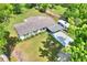 Aerial view of the property showcasing the house, a covered parking area, and large yard at 12631 Hobson Simmons Rd, Lithia, FL 33547