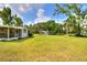 Backyard with view of the home, outbuilding and landscaping at 12631 Hobson Simmons Rd, Lithia, FL 33547