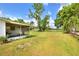 View of the backyard with ample lawn and landscaping at 12631 Hobson Simmons Rd, Lithia, FL 33547