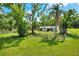 Spacious backyard with mature trees and fencing for added privacy and security at 12631 Hobson Simmons Rd, Lithia, FL 33547