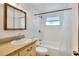 Bathroom featuring shower over tub, a white vanity, and natural light from the window at 12631 Hobson Simmons Rd, Lithia, FL 33547