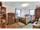 Bedroom featuring an ornate wood dresser, a bed, and natural light from the windows at 12631 Hobson Simmons Rd, Lithia, FL 33547