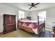Bedroom featuring a beautiful wood bed frame, matching dresser, and natural light at 12631 Hobson Simmons Rd, Lithia, FL 33547