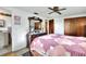 Bedroom featuring a bed, dresser with mirror, and wood closet doors at 12631 Hobson Simmons Rd, Lithia, FL 33547