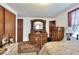 Bedroom with ornate wood dresser and mirror and wood closet doors at 12631 Hobson Simmons Rd, Lithia, FL 33547