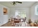 Cozy dining area featuring a ceiling fan, tile floors, and natural light from the window at 12631 Hobson Simmons Rd, Lithia, FL 33547