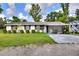 Charming single-story home featuring a large front yard, covered parking, and well-maintained lawn at 12631 Hobson Simmons Rd, Lithia, FL 33547
