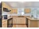 Well-lit kitchen featuring ample countertop space, neutral colored cabinets, and a functional layout at 12631 Hobson Simmons Rd, Lithia, FL 33547