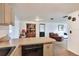 Open-concept kitchen offering seamless transition to the living room and dining areas with black dishwasher at 12631 Hobson Simmons Rd, Lithia, FL 33547
