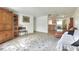 Spacious living room with neutral paint, patterned rug, and an open layout connecting to the dining and kitchen areas at 12631 Hobson Simmons Rd, Lithia, FL 33547
