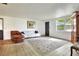 Bright living room with lots of light, featuring a sofa, lounger, patterned rug and neutral colored walls at 12631 Hobson Simmons Rd, Lithia, FL 33547