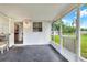 View of a screened porch with access to the yard and kitchen at 12631 Hobson Simmons Rd, Lithia, FL 33547
