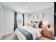 Bright bedroom featuring a cozy bed, stylish decor, and a window with natural light at 13245 Tropical Breeze Way, Hudson, FL 34669