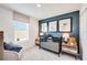 A charming Bedroom with a crib, playful decor, and a comfortable armchair by the window at 13245 Tropical Breeze Way, Hudson, FL 34669