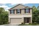 Charming two-story home with neutral siding, shutters and a two car garage at 13245 Tropical Breeze Way, Hudson, FL 34669