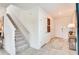 Bright foyer featuring tile flooring and a staircase leading to the upper level at 13245 Tropical Breeze Way, Hudson, FL 34669