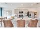 Modern kitchen featuring a granite island, stainless steel appliances and stylish woven bar stools at 13245 Tropical Breeze Way, Hudson, FL 34669