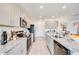 Well-lit kitchen with modern appliances, granite countertops, and a functional design for cooking at 13245 Tropical Breeze Way, Hudson, FL 34669