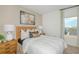 Relaxing bedroom with a woven headboard, a large art print, and a bright window at 13548 Tropical Breeze Way, Hudson, FL 34669