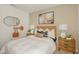 Inviting bedroom showcasing a cozy bed, bedside tables, lamps, and stylish decor at 13548 Tropical Breeze Way, Hudson, FL 34669