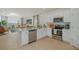 Modern kitchen with stainless steel appliances, quartz countertops, and an open concept design at 13548 Tropical Breeze Way, Hudson, FL 34669
