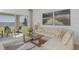 Cozy living room with a large sectional, access to outdoor patio, and stylish decor at 13548 Tropical Breeze Way, Hudson, FL 34669