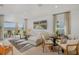 Bright living room with neutral decor, large sectional, modern rug, and outdoor access at 13548 Tropical Breeze Way, Hudson, FL 34669