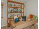 Office featuring rustic wood desk with shelving holding books, decor and a painting on the wall at 13548 Tropical Breeze Way, Hudson, FL 34669