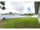 This backyard features a green lawn and a white fence surrounding the property at 1461 S Hillcrest Ave, Clearwater, FL 33756