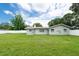 This backyard features a green lawn and siding and a white fence surrounding the property at 1461 S Hillcrest Ave, Clearwater, FL 33756