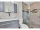 Modern bathroom featuring a tiled shower with glass door and gray vanity at 1461 S Hillcrest Ave, Clearwater, FL 33756
