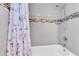 Bright bathroom features tile walls, showerhead, tub and decorative tile accents at 1461 S Hillcrest Ave, Clearwater, FL 33756