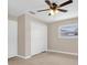 Cozy bedroom with carpet flooring, ceiling fan, and closet space at 1461 S Hillcrest Ave, Clearwater, FL 33756