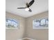 This bedroom features a ceiling fan, neutral walls, polished floor and two windows for natural light at 1461 S Hillcrest Ave, Clearwater, FL 33756