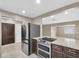 Contemporary kitchen with stainless steel appliances, a spacious island, and ample cabinet space at 1461 S Hillcrest Ave, Clearwater, FL 33756