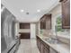 Modern kitchen featuring stainless steel appliances, dark wood cabinetry, and a sleek countertop sink at 1461 S Hillcrest Ave, Clearwater, FL 33756