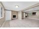 Comfortable living room with fireplace, tile flooring, and ample natural light at 1461 S Hillcrest Ave, Clearwater, FL 33756