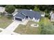 Elevated angle of the home highlighting the dark roof, gray garage door, and manicured lawn at 15012 Winterwind Dr, Tampa, FL 33624