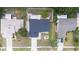 Top-down view of the home showcasing the dark roof, manicured lawn, and surrounding landscaping at 15012 Winterwind Dr, Tampa, FL 33624