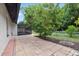 Tile patio overlooks a landscaped backyard with mature trees and lush greenery at 15012 Winterwind Dr, Tampa, FL 33624