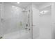 Luxurious bathroom featuring glass shower enclosure, tub, and high-end fixtures at 15012 Winterwind Dr, Tampa, FL 33624