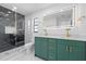 Modern bathroom with a glass shower, double sink vanity, and ample lighting at 15012 Winterwind Dr, Tampa, FL 33624