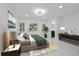 Bedroom with a view of the ensuite bath, featuring a large comfortable bed and stylish decor at 15012 Winterwind Dr, Tampa, FL 33624