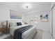 Digitally staged bright bedroom with clean lines, fan, natural light, and modern flooring at 15012 Winterwind Dr, Tampa, FL 33624