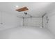 Spacious two car garage with a white door and room for storage at 15012 Winterwind Dr, Tampa, FL 33624