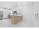 Bright kitchen with modern appliances, countertops, and an island with barstool seating at 15012 Winterwind Dr, Tampa, FL 33624