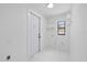 Well-lit laundry room featuring sleek white design, storage shelves, and modern utility connections at 15012 Winterwind Dr, Tampa, FL 33624