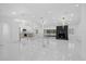 Bright living room with fireplace, open floorplan, and modern lighting fixtures above at 15012 Winterwind Dr, Tampa, FL 33624