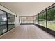 Enclosed patio with tile flooring and view of the well-maintained yard at 15012 Winterwind Dr, Tampa, FL 33624